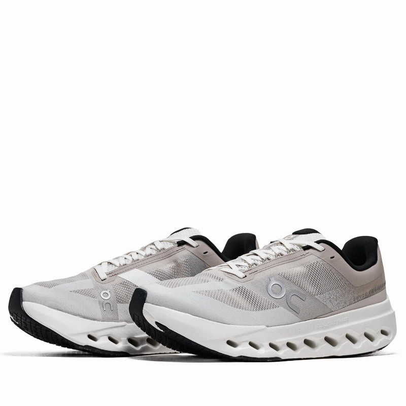 On Cloudsurfer Next - Fog/Ivory running in a mesa area shoes