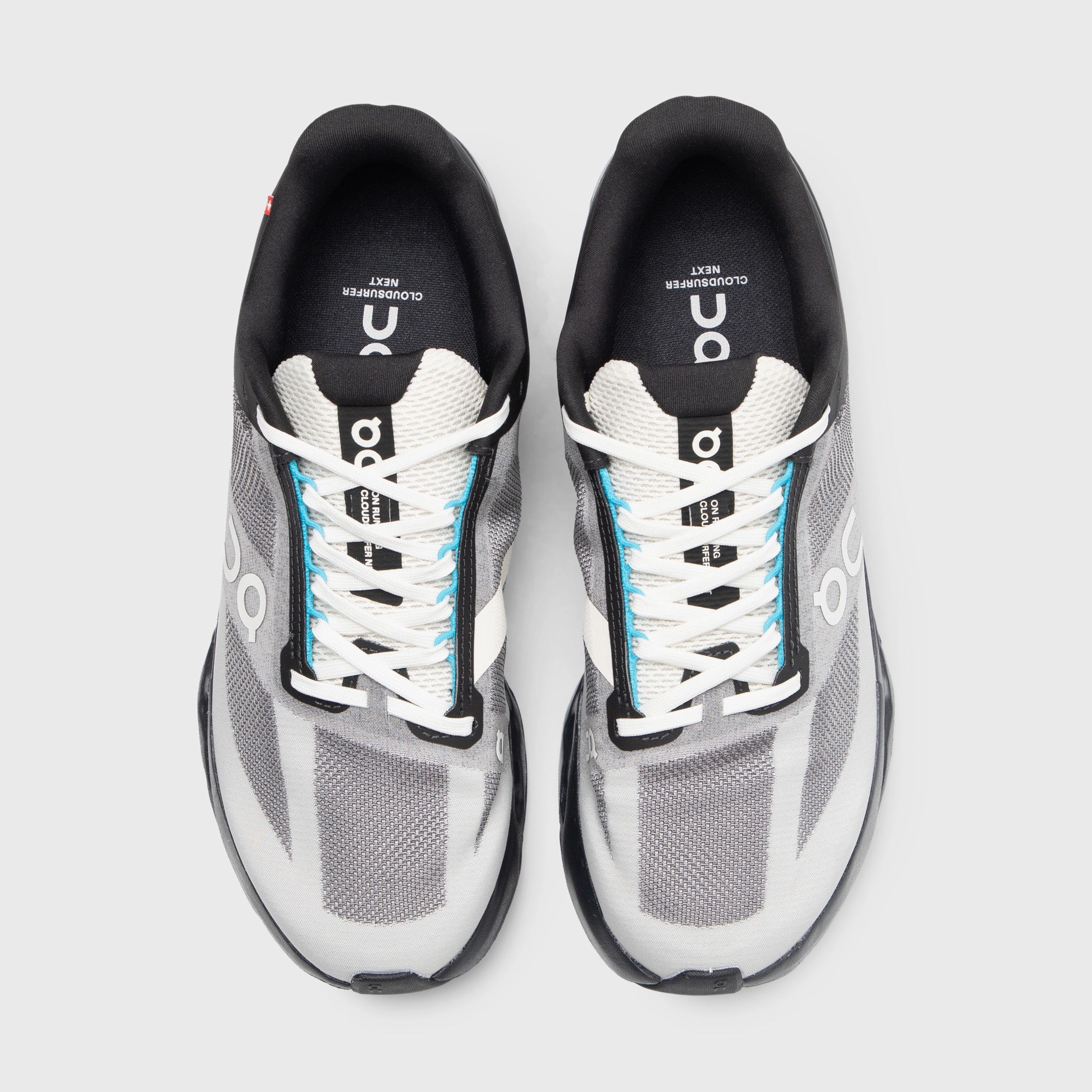 On Cloudsurfer Black / Beige running in mud shoes hand - washable shoes