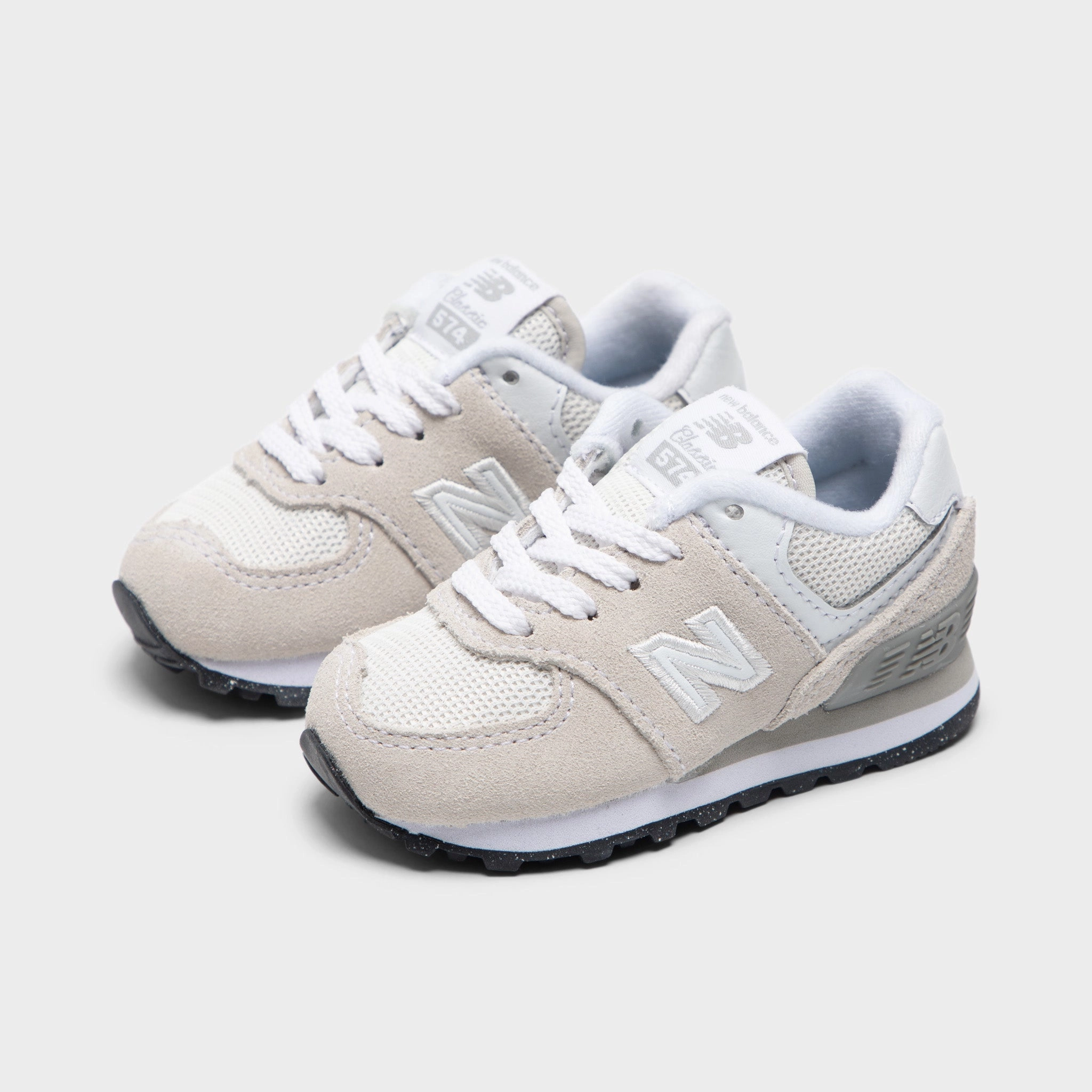 New Balance Infants' 574 Light Grey / White running in a river area shoes