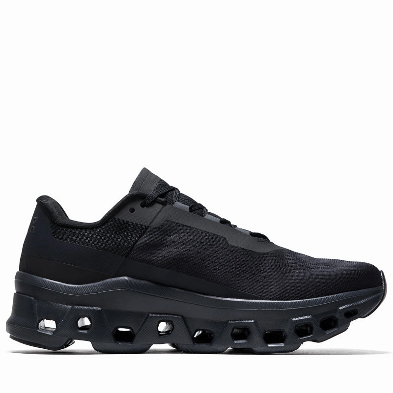 On Cloudmonster - All Black running on a track oval
